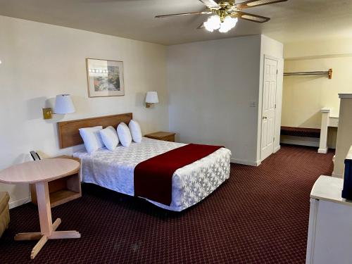 Rodeway Inn - Santa Fe Inn في وينيموكا: غرفة الفندق بسرير وطاولة