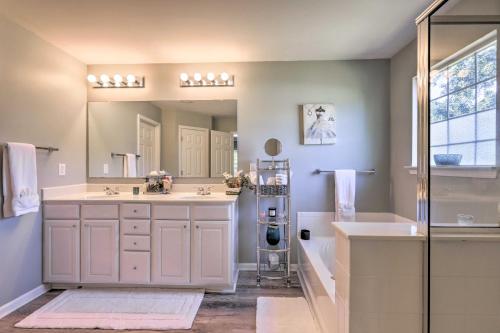 a bathroom with two sinks and a shower and a mirror at Family Home, 23Mi to DWTN Atlanta and Aquarium in Stockbridge