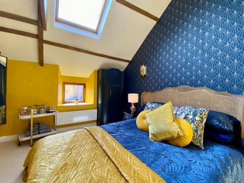 a bedroom with a bed with yellow pillows on it at The Stables in Yate