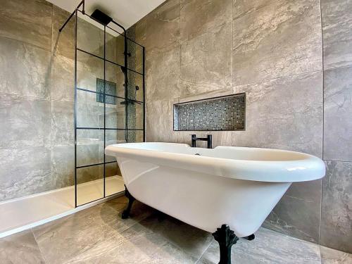 a bathroom with a white sink and a shower at The Stables in Yate