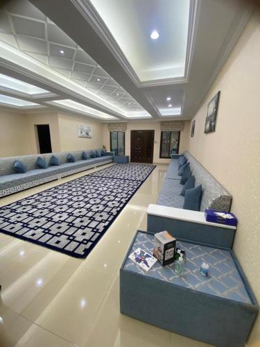 a waiting room with couches and a table in a building at The Fort Farm in Suḩaybah