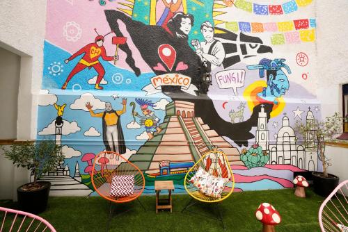 a mural on the side of a wall in a room at Hostal Fungi Casa Rosa in Mexico City