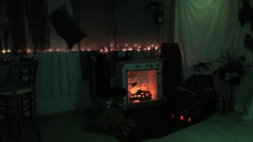 a living room with a fireplace with candles in it at Eleni Apartments in Hersonissos