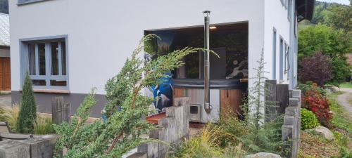 a house with a dog sitting in the front door at Locations des 3 sommets avec Sauna et Spa en Alsace in Sondernach