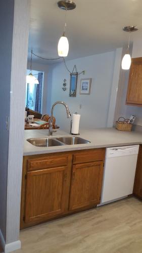 a kitchen with a sink and a counter top at 2 Bedroom Condo in Rehoboth Beach w/ New Bed in Rehoboth Beach