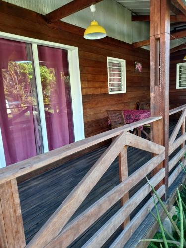 a front porch of a house with a wooden fence at Couleurs îsles in Montjoly