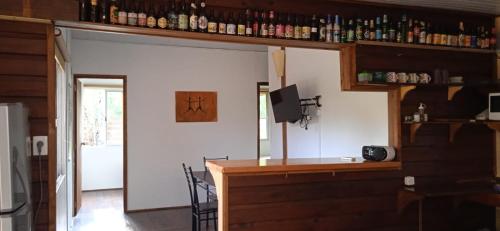 a room with a bar with a tv on a wall at MZion in Piriápolis
