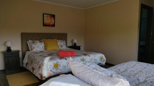 a bedroom with a bed with a bedspread on it at Hospedaje Familiar El Encanto in Puyehue