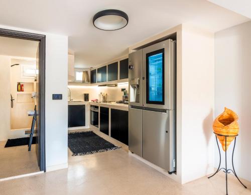 a kitchen with a large stainless steel refrigerator at Black and White Apartment in Pollonia