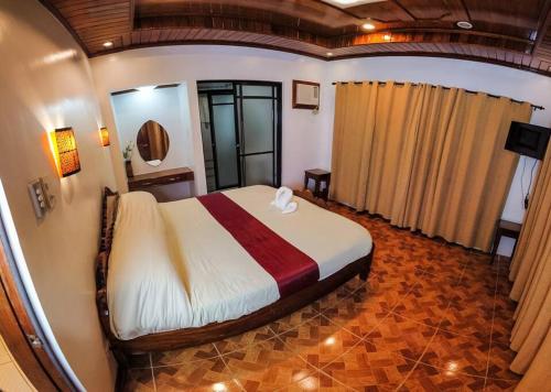a bedroom with a large bed in a room at Twin House Villa in Coron