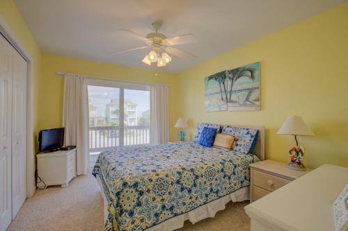 a bedroom with a bed and a window at Surf and Sound in North Topsail Beach