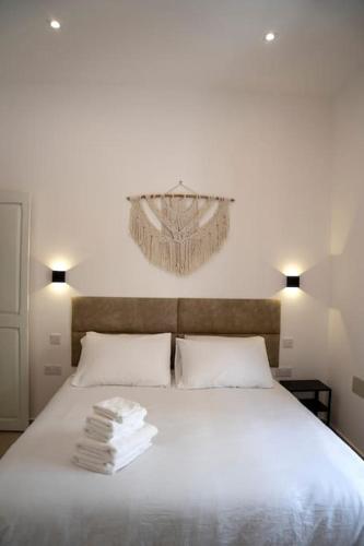 a bedroom with a white bed with towels on it at The Olive 3 - Traditional Maltese Accommodation in Vittoriosa