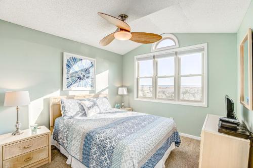 a bedroom with a bed and a ceiling fan at Carolina Daze in Topsail Beach
