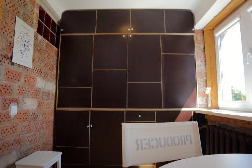 a large black cabinet in a room with a table at Mini cinema & movie studio with PS5 in Riga