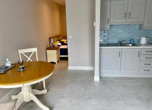 a kitchen with a wooden table and a sink at Erne Getaway No.5 Brand new 1 bed apartment in Enniskillen