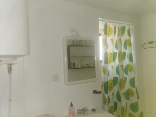 a bathroom with a sink and a mirror at casa luna cuesta del rio 15 in Valdeganga