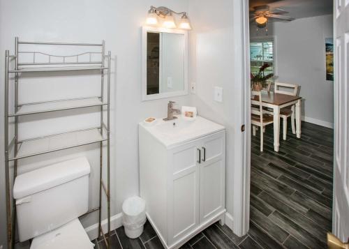 a white bathroom with a sink and a toilet at Breaking Even House in Fort Morgan