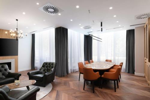 a dining room with a table and chairs at Radisson Blu Hotel, Cluj in Cluj-Napoca
