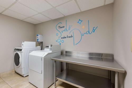 a laundry room with a washing machine and writing on the wall at Sonesta Select Tempe Downtown in Tempe