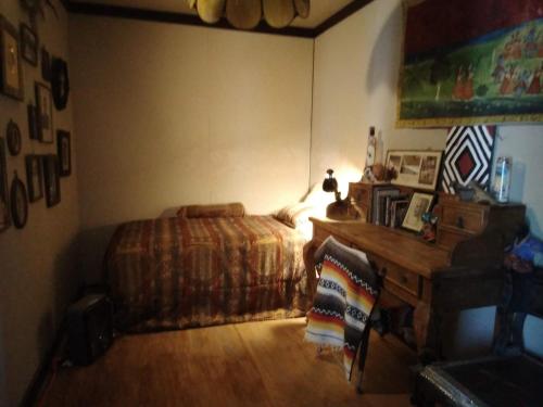 a bedroom with a bed and a desk in it at La Loma del Chivo Llc - The Spirit room in Marathon
