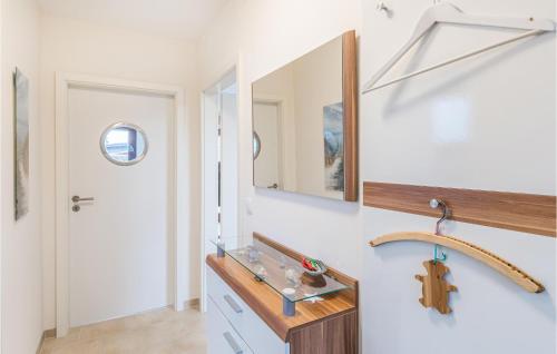 a bathroom with a sink and a mirror at 2 Bedroom Gorgeous Home In Hennstedt in Hennstedt