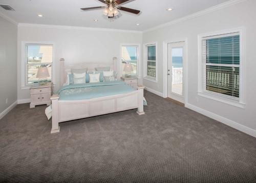 a bedroom with a bed in a room with windows at Shiloh House in Fort Morgan