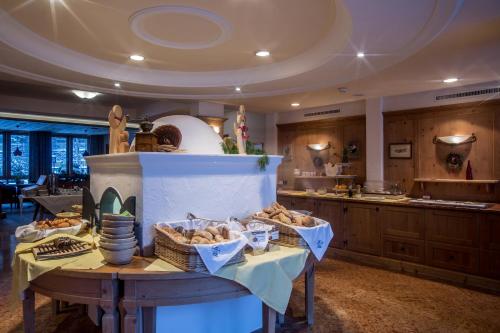 a kitchen with a table with baskets of bread at Hotel Gotthard in Lech am Arlberg
