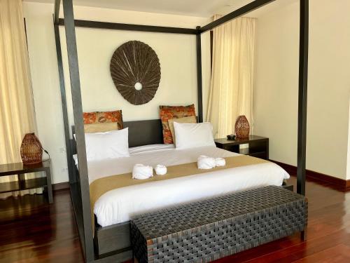 a bedroom with a large bed with two towels on it at Villa Nirwana - Jasmin 3BR with private pool in Ban Ang Thong