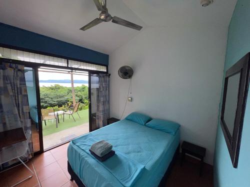 a bedroom with a bed and a sliding glass door at Blue Dream Kite Boarding Resort Costa Rica in Puerto Soley