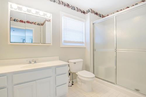 a white bathroom with a shower and a toilet at Avalon Topsail Beach in Topsail Beach