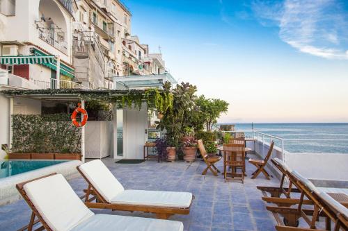 a balcony with chairs and a view of the ocean at Hotel Marina Riviera in Amalfi