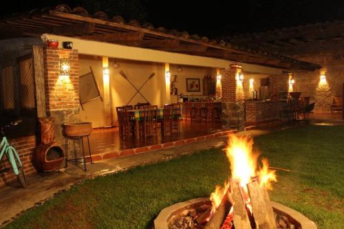 a fire pit in front of a house at night at Rustic Luxury Retreat Near Historic Zacatlan in Zacatlán
