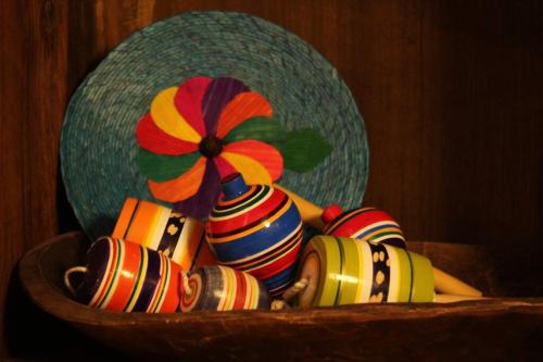 a basket filled with colorful vases with a flower on it at Rustic Luxury Retreat Near Historic Zacatlan in Zacatlán