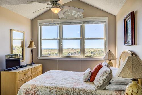 a bedroom with a bed and a window at Baylin A in Topsail Beach