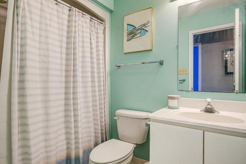 a bathroom with a toilet and a sink at Baylin A in Topsail Beach