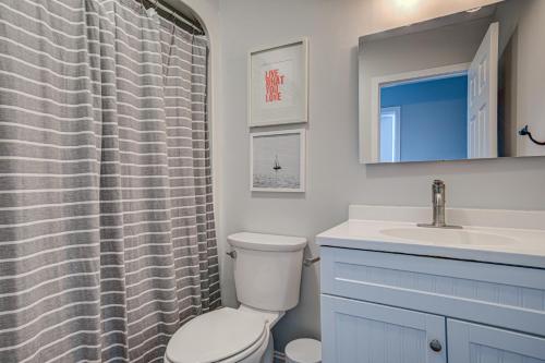 a bathroom with a toilet and a sink at Light Oasis in Topsail Beach