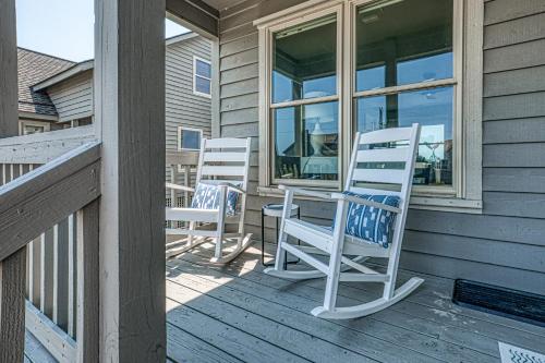 two rocking chairs sitting on the porch of a house at Light Oasis in Topsail Beach
