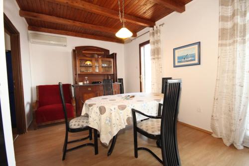 a dining room with a table and chairs at Apartments by the sea Molunat, Dubrovnik - 8550 in Molunat