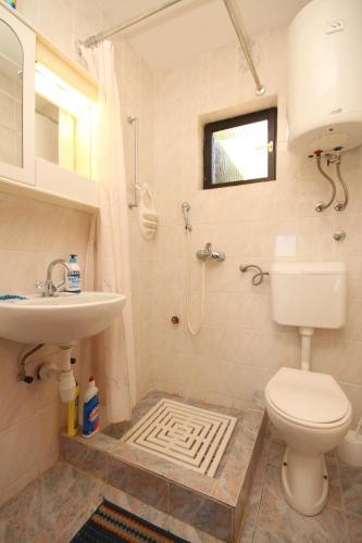 a bathroom with a toilet and a sink at Apartments with parking space Rukavac, Vis - 8836 in Vis