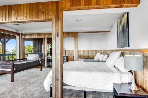 a bedroom with a king sized bed and a balcony at Buck Mountain Home 