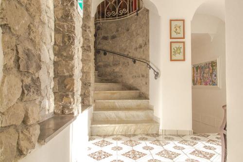 a staircase in a house with a stone wall at Hotel Marina Riviera in Amalfi