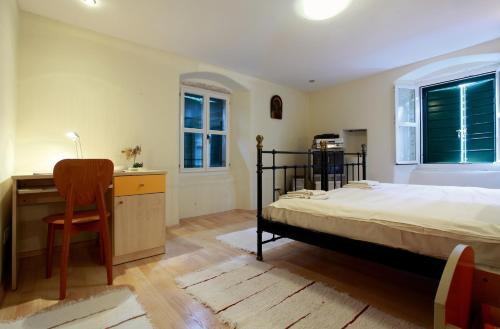 a bedroom with a bed and a desk and a chair at Apartments with WiFi Split - 8672 in Split