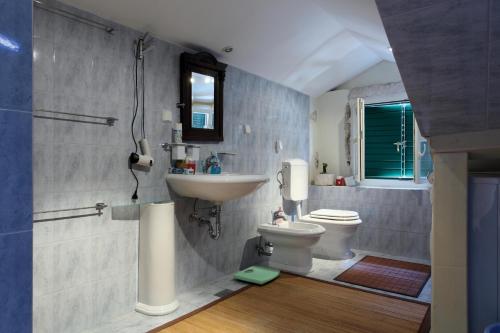 a bathroom with a sink and a toilet at Apartments with WiFi Split - 8672 in Split