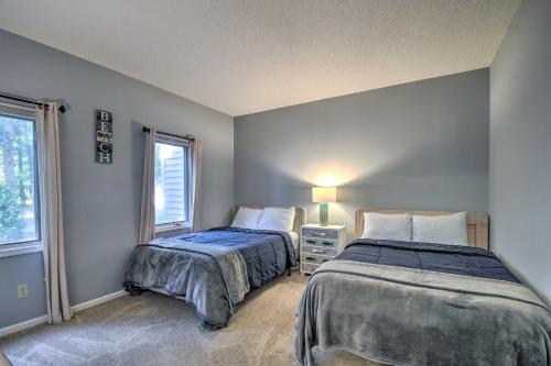 two beds in a room with two windows at Coastal Golf Resort Condo Less Than 4 Mi to Beach! in North Myrtle Beach