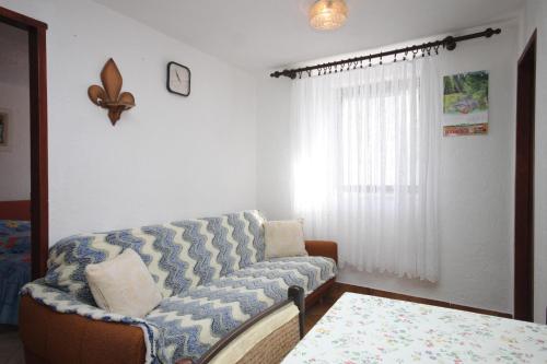 a living room with a couch and a table at Apartment Stivan 382d in Štivan