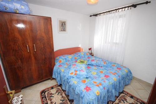 a bedroom with a bed and a wooden cabinet at Apartment Stivan 382d in Štivan