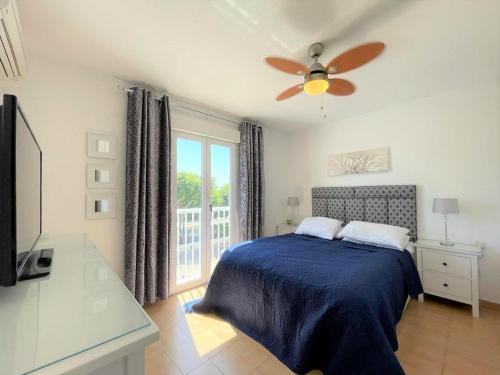 a bedroom with a bed and a ceiling fan at Modern holiday home in Roquetas de Mar with private terrace in Roquetas de Mar