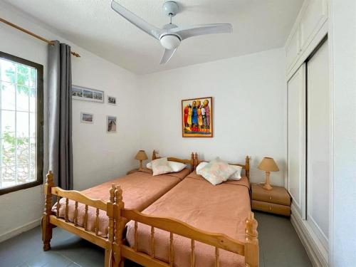 a bedroom with a bed with a ceiling fan at Inviting holiday home in Roquetas de Mar with terrace in Roquetas de Mar
