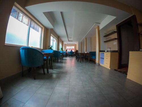a hallway with chairs and tables in a building at Hotel Mega & Apartment in Kathmandu
