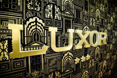 a sign with the word love on a wall at Hotel Luxor in Lublin